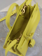 YSL yellow leather handbag interior view with top handles and zipper hardware