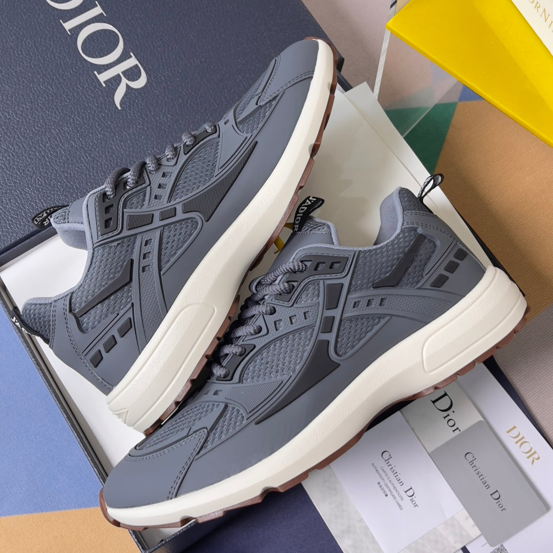 Unisex Dior chunky runners in blue-gray with textured panels and off-white midsole.