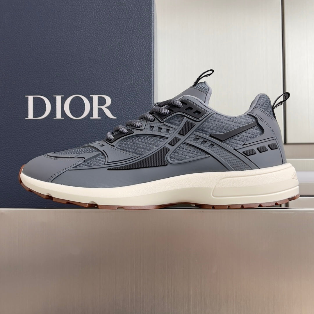 Unisex Dior lace-up sneakers in blue-gray with chunky off-white sole and side panels.