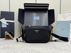 Black Prada crossbody bag with front logo plaque and adjustable shoulder strap.