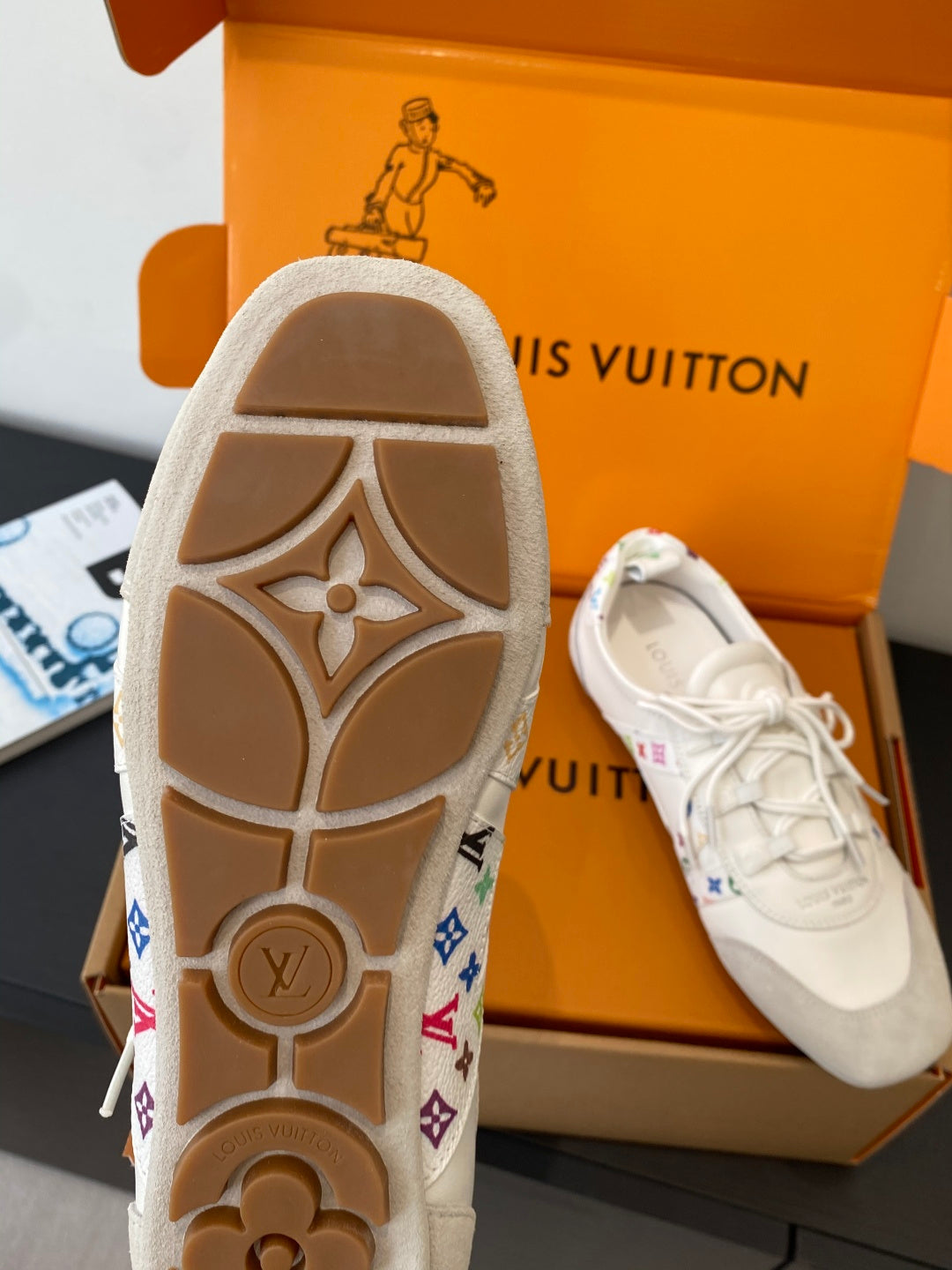 White sneaker outsole with patterned side accents and tread detail, shown with shoe