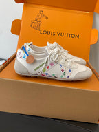 White unisex sneakers with multicolor patterned side panels and white lace-up closure