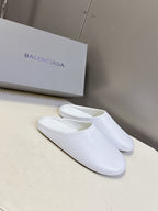 White slide sandals with wide strap and embossed logo on upper
