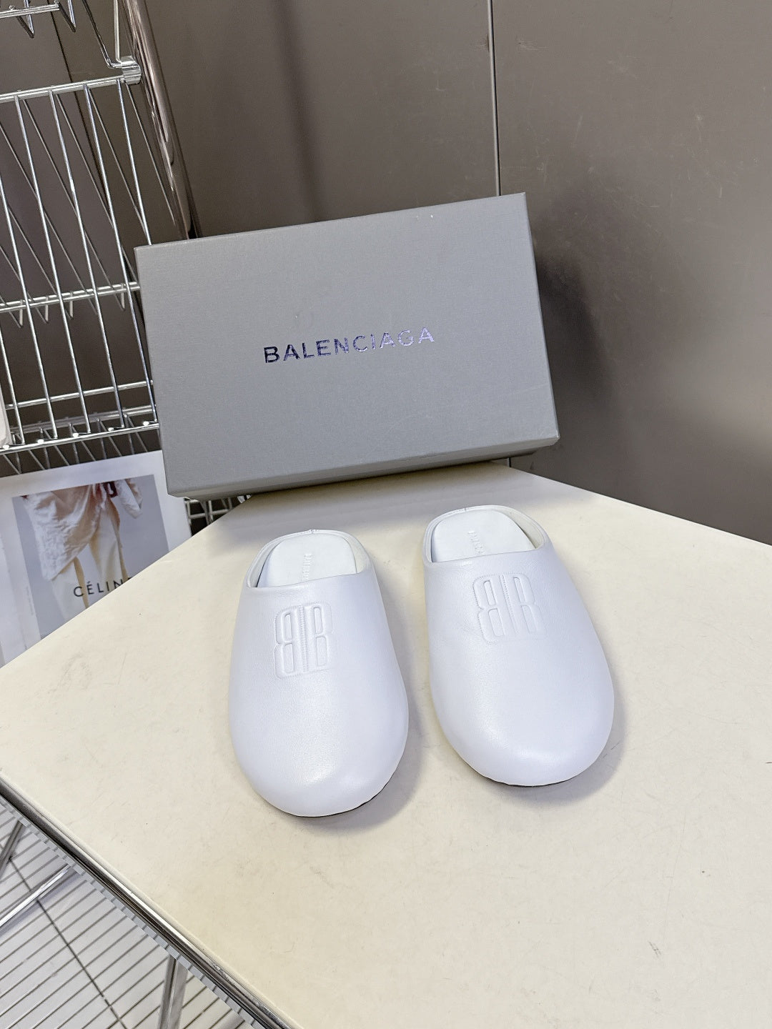 Balenciaga white slide sandals with embossed logo on top