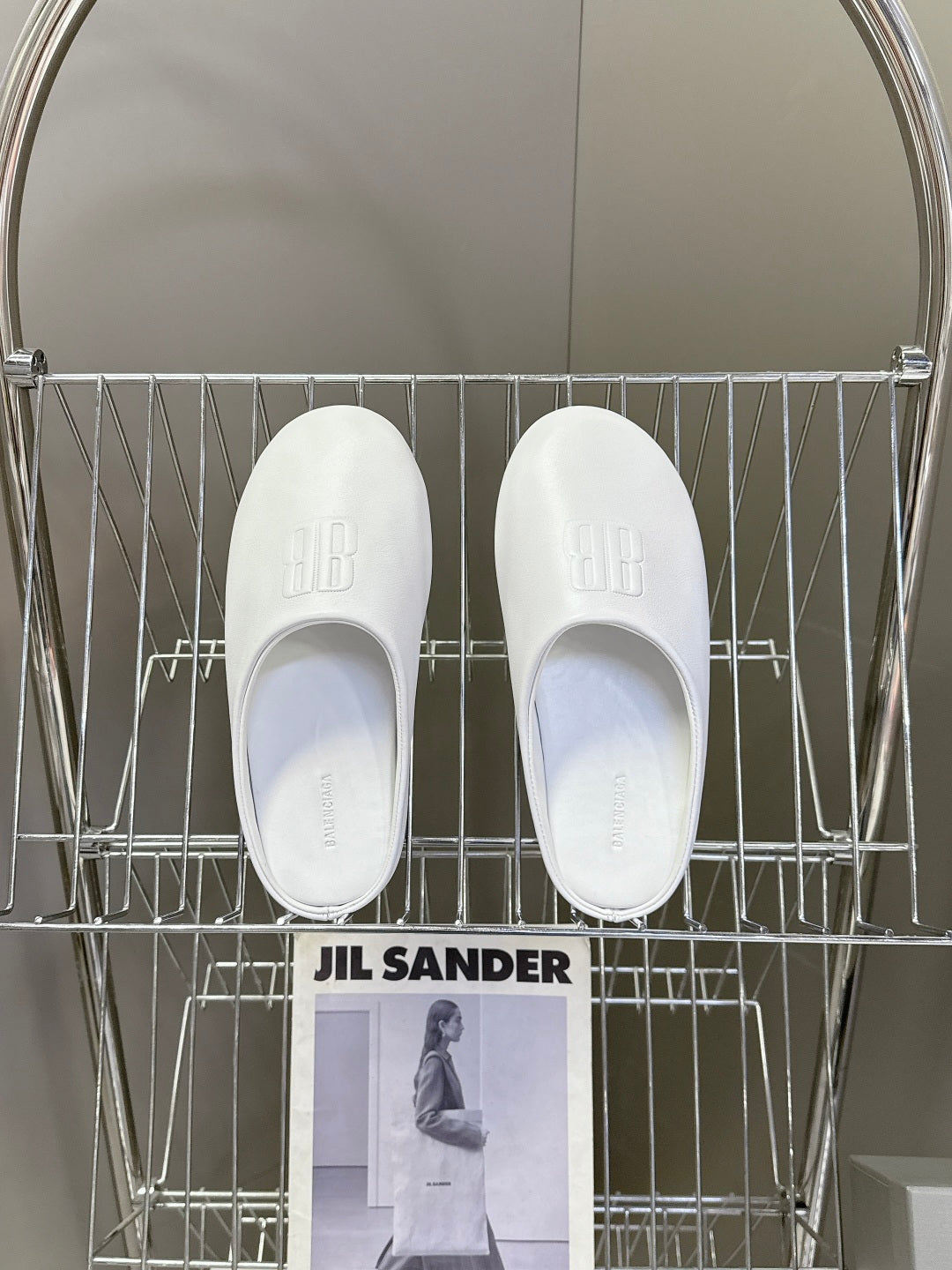 Pair of white slide sandals with embossed logo on top