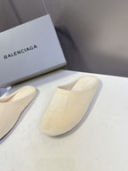Balenciaga slide sandals, light beige, one sandal shown with embossed logo