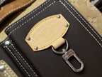 Close-up of engraved metal tag on Louis Vuitton handbag with hook key ring