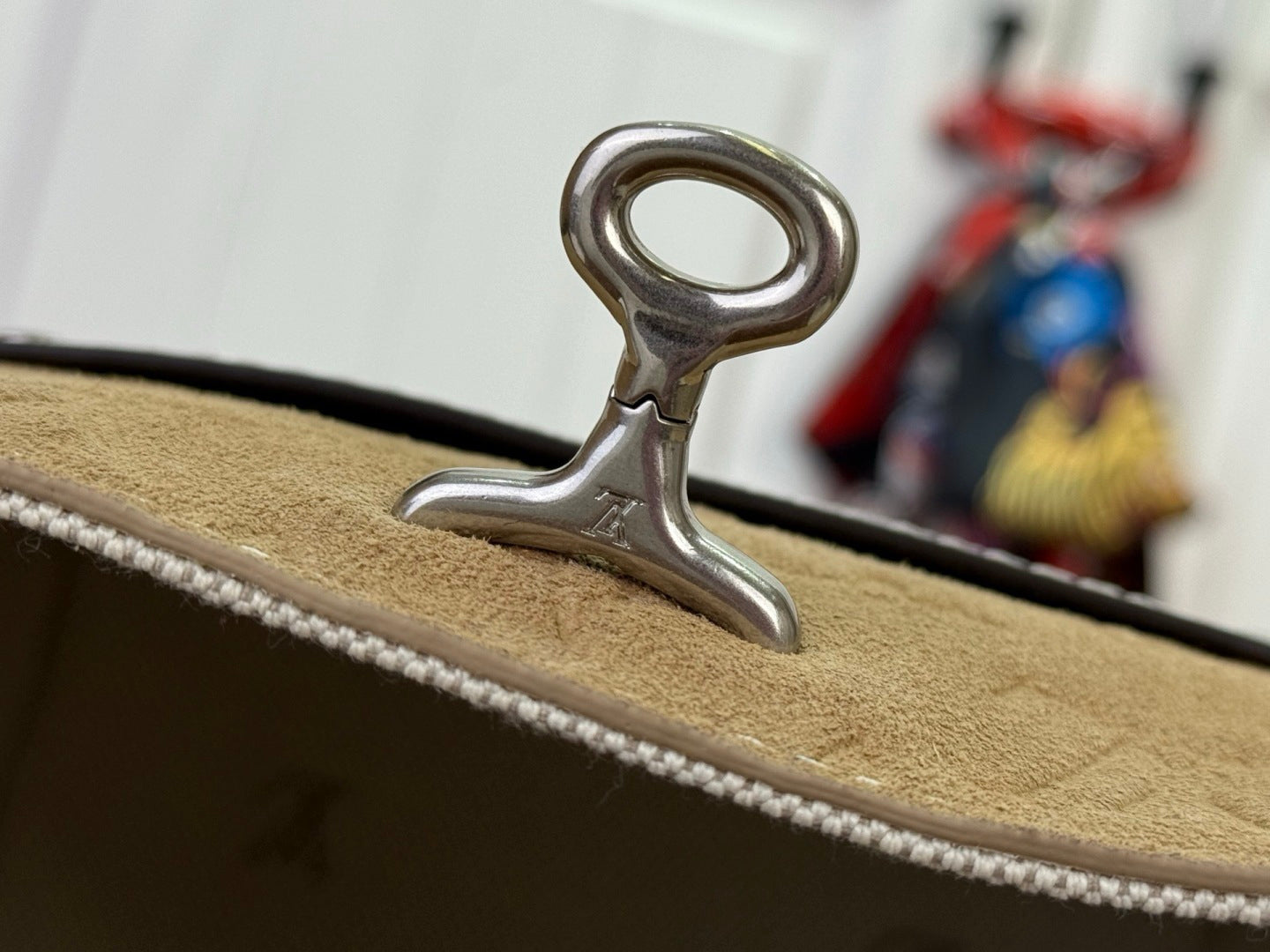Louis Vuitton bag clasp with metal hook on tan leather trim