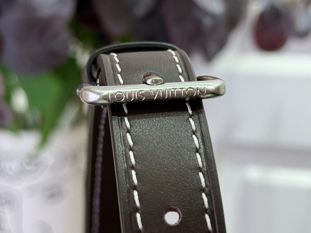 Top leather strap with metal buckle embossed Louis Vuitton on small bag