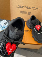 Black sneakers with red LV heart logo and lace-up front detail