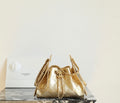 Chanel quilted metallic-gold bucket bag with chain straps and drawstring closure