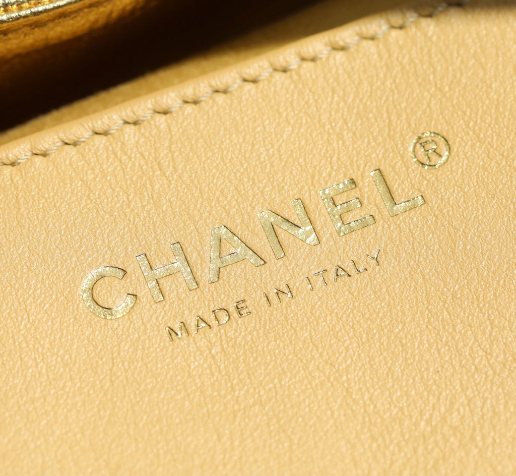 Gold leather patch with CHANEL logo and MADE IN ITALY embossing