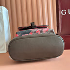Gucci backpack bottom and base view with dark brown textured leather panel