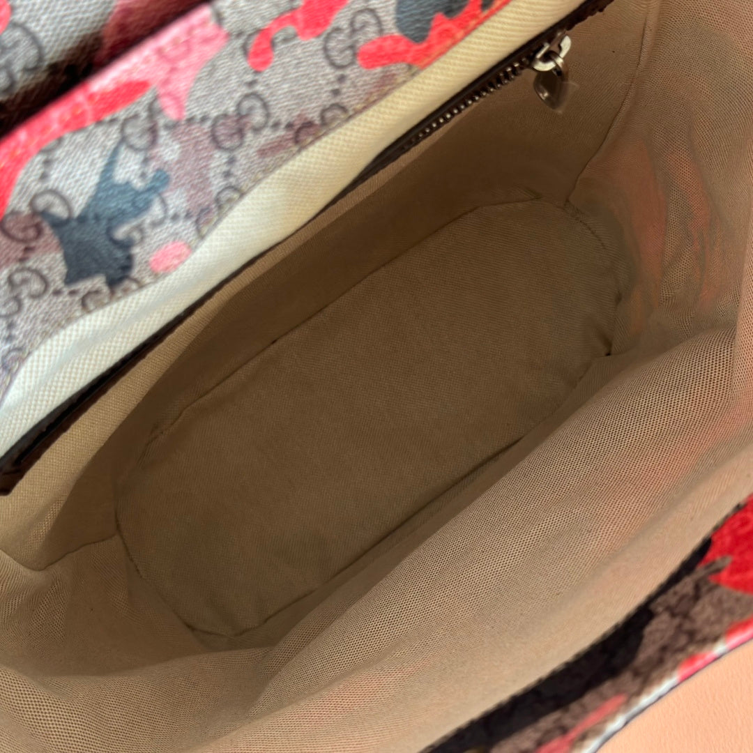 Gucci backpack interior view with beige lining and open top zipper opening