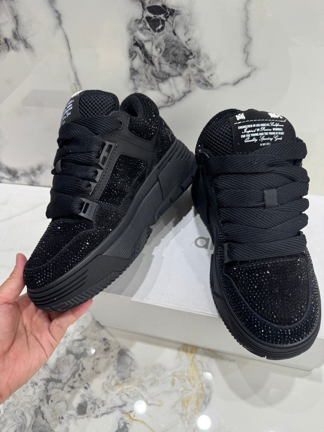 Amiri luxury shoes black lace-up low-top sneakers with speckled panels and tongue patch