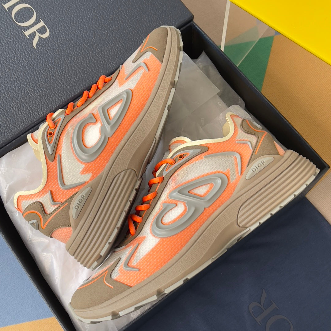 Dior unisex sneakers, side view with orange laces and ribbed gray rubber sole