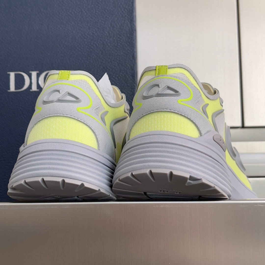 Dior unisex sneakers, heel view, neon lime uppers on light gray ribbed soles