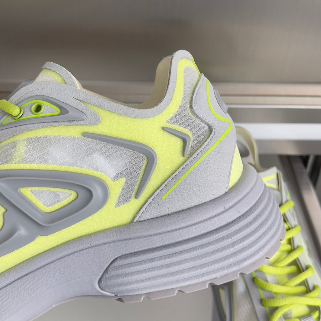 Close-up Dior sneakers, neon lime and light gray upper with chunky ribbed sole