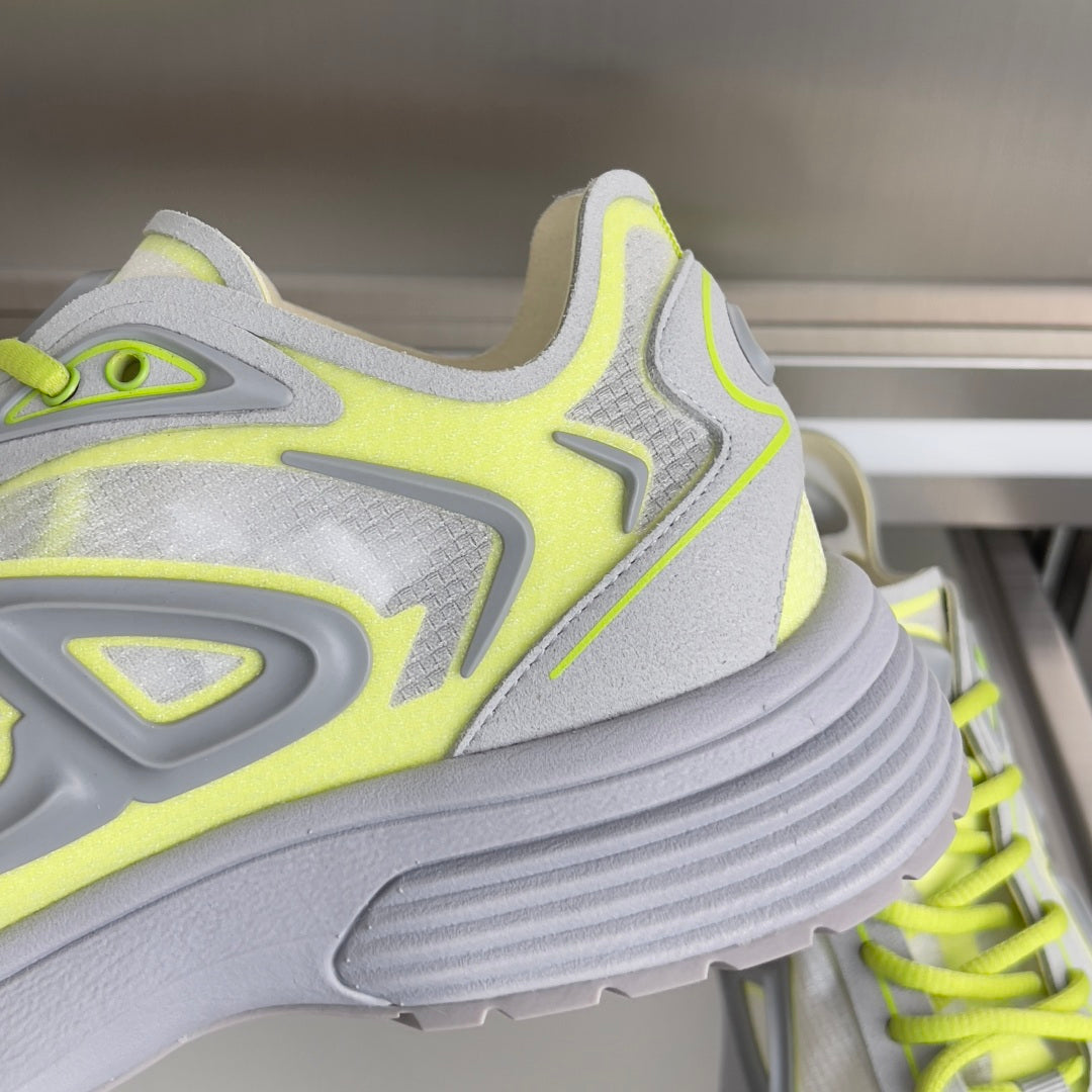 Close-up Dior sneakers, neon lime and light gray upper with chunky ribbed sole