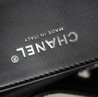 Black leather label close-up with "CHANEL" text and "MADE IN ITALY"