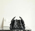 Black quilted bucket bag with chain handles and drawstring closure with CC charm
