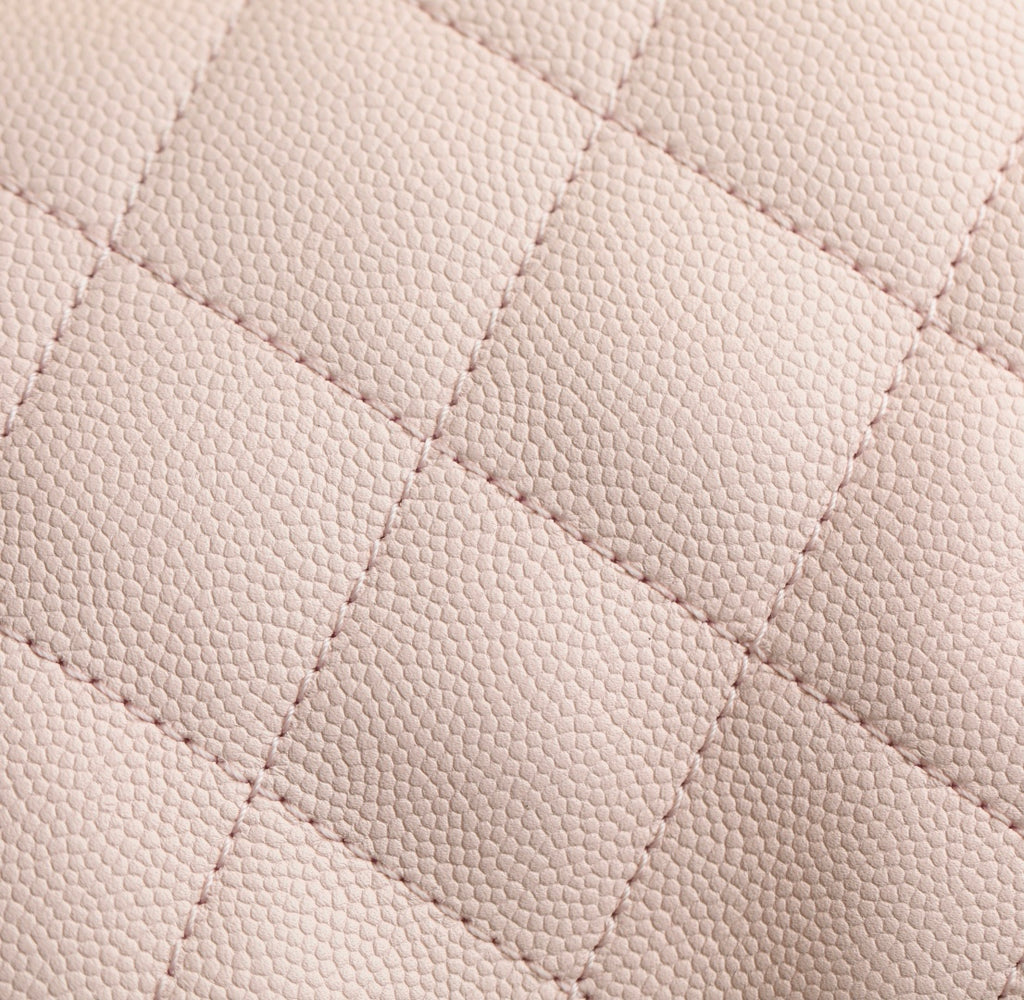 Pink quilted leather surface with fine diamond stitching