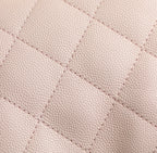 Pink quilted leather surface with fine diamond stitching