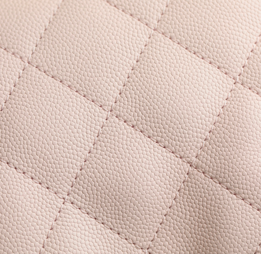 Pink quilted leather surface with fine diamond stitching