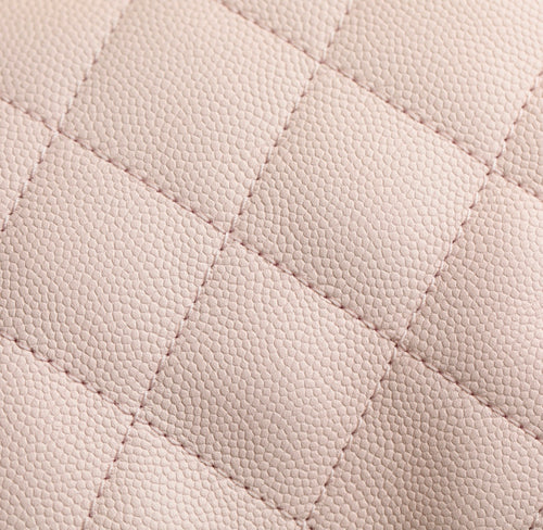 Pink quilted leather surface with fine diamond stitching