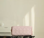 Pink Chanel quilted flap bag with short handles and structured front
