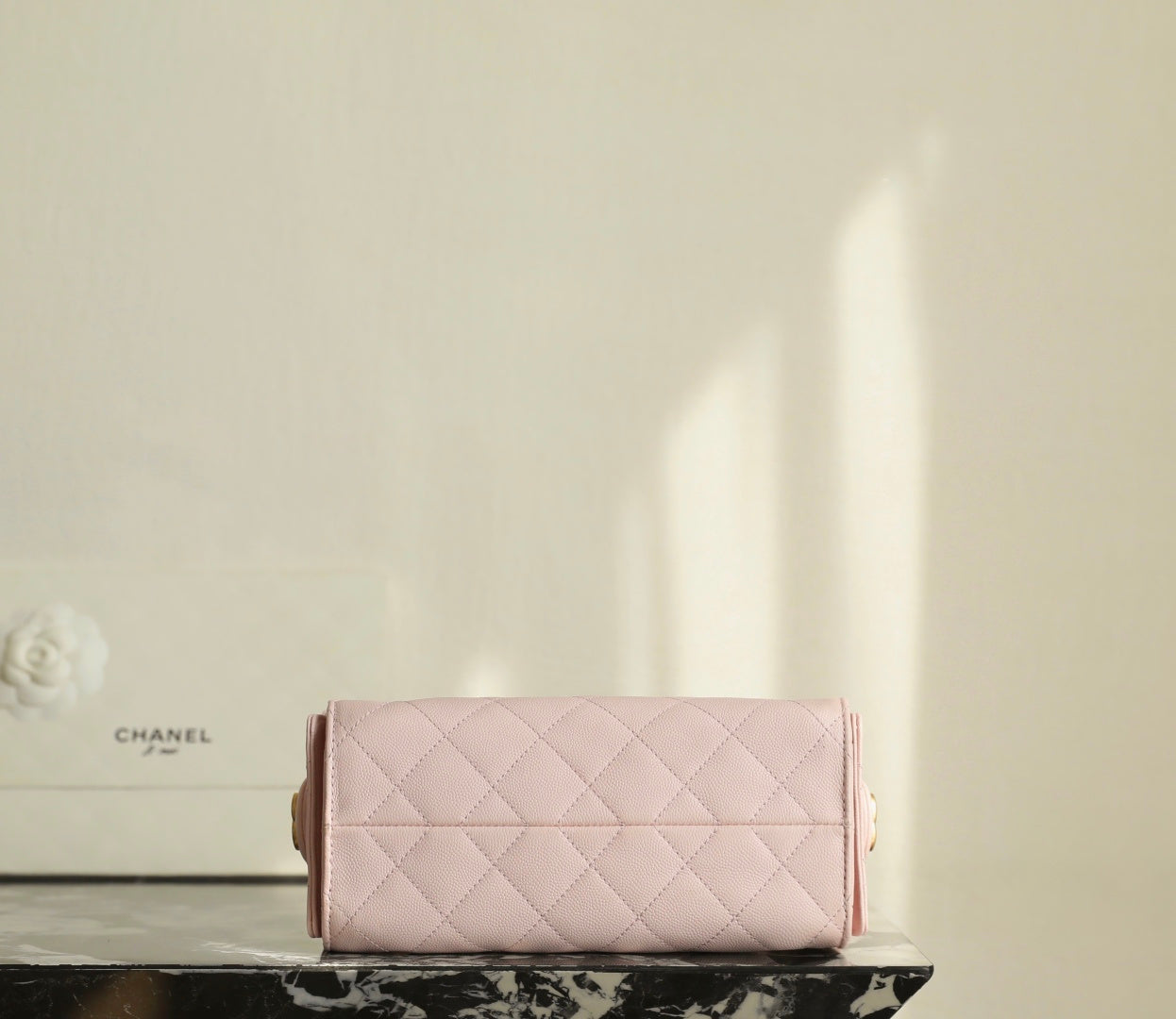 Pink Chanel quilted flap bag with short handles and structured front