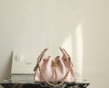 Pink Chanel drawstring bag with gold chain and central clasp, quilted panels