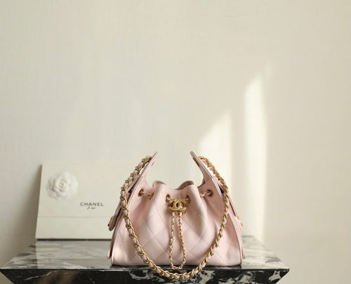 Pink Chanel drawstring bag with gold chain and central clasp, quilted panels