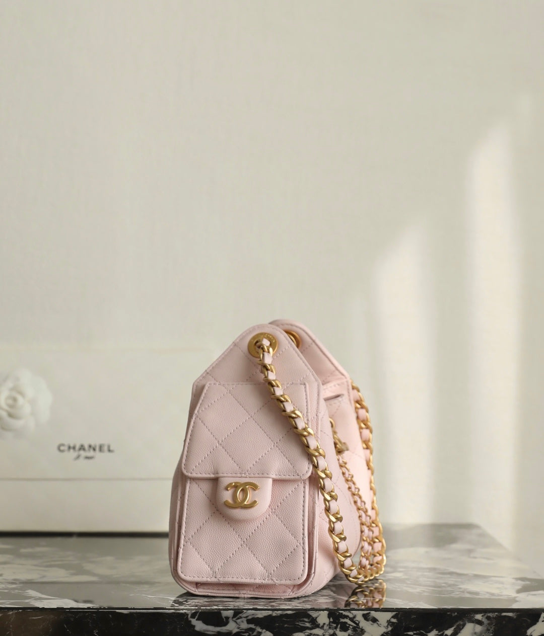 Pink Chanel shoulder bag with gold chain detail and logo front medallion