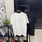 Cotton T-shirts on hangers, white and black, with embroidered Burberry logo