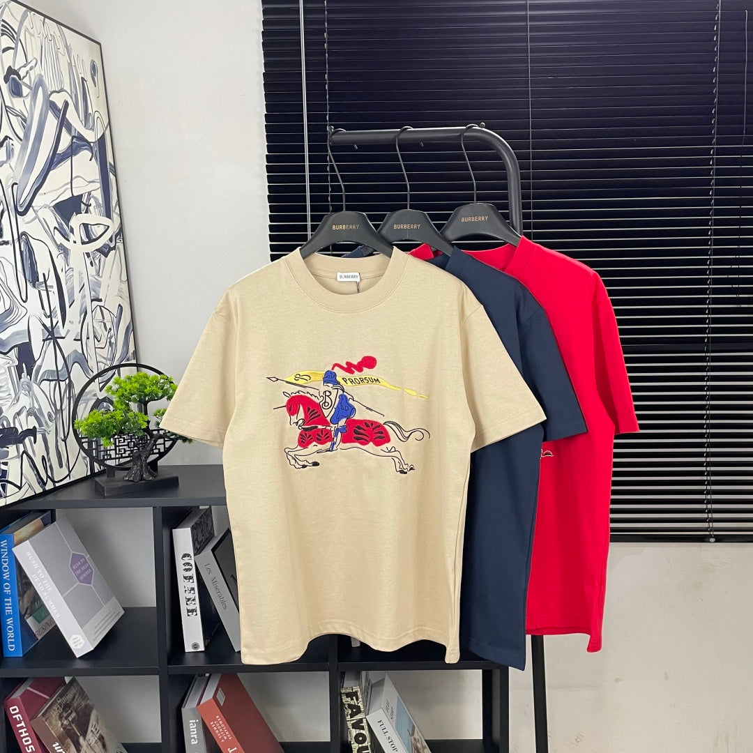 Cream, navy, and red short-sleeve T-shirts with colorful graphic prints on front.