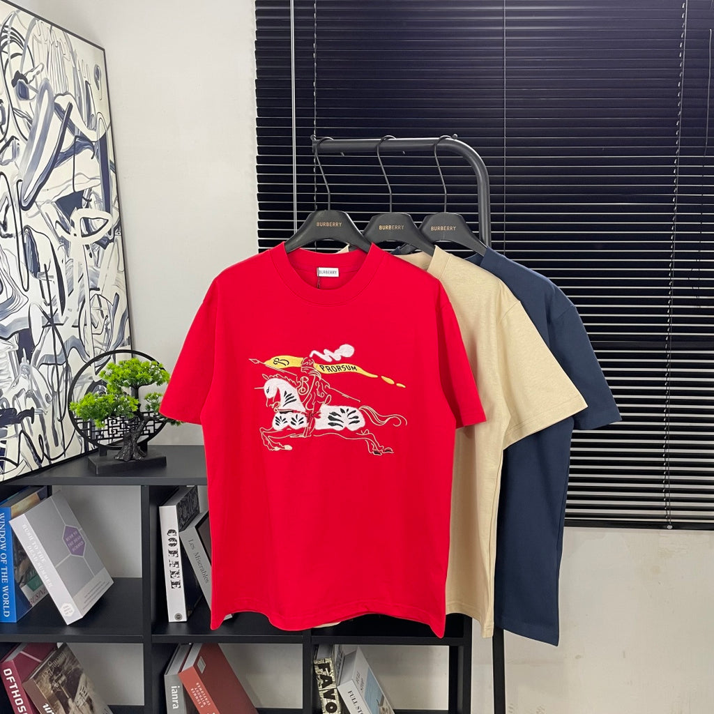 Red short-sleeve T-shirt with colorful graphic print, crew neck, on hangers.