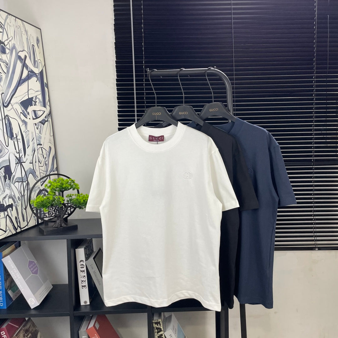 Short-sleeve T-shirt display: white tee on hanger among dark tees