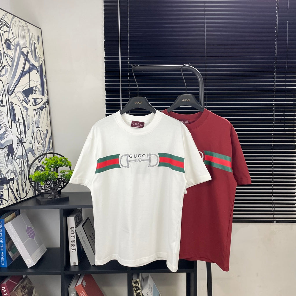 White and red short-sleeve T-shirts on hangers with green stripe and horsebit logo