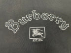 Embroidered Burberry wordmark, horse crest, and EST1856 patch on black fabric.