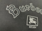 Large embroidered Burberry wordmark and horse crest with EST1856 on black T-shirt.