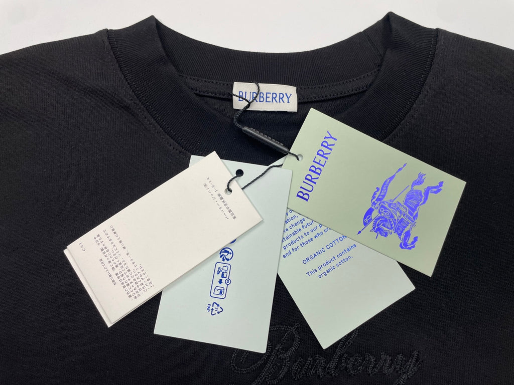 Burberry crewneck T-shirt on hanger, dark fabric with hanging product tags