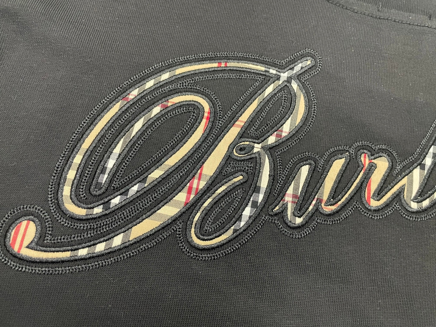 Burberry embroidered script logo detail on dark charcoal T-shirt