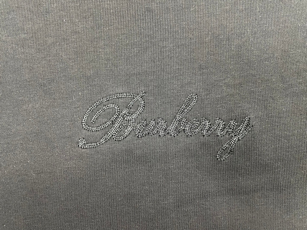 Burberry embroidered script logo on dark charcoal T-shirt fabric