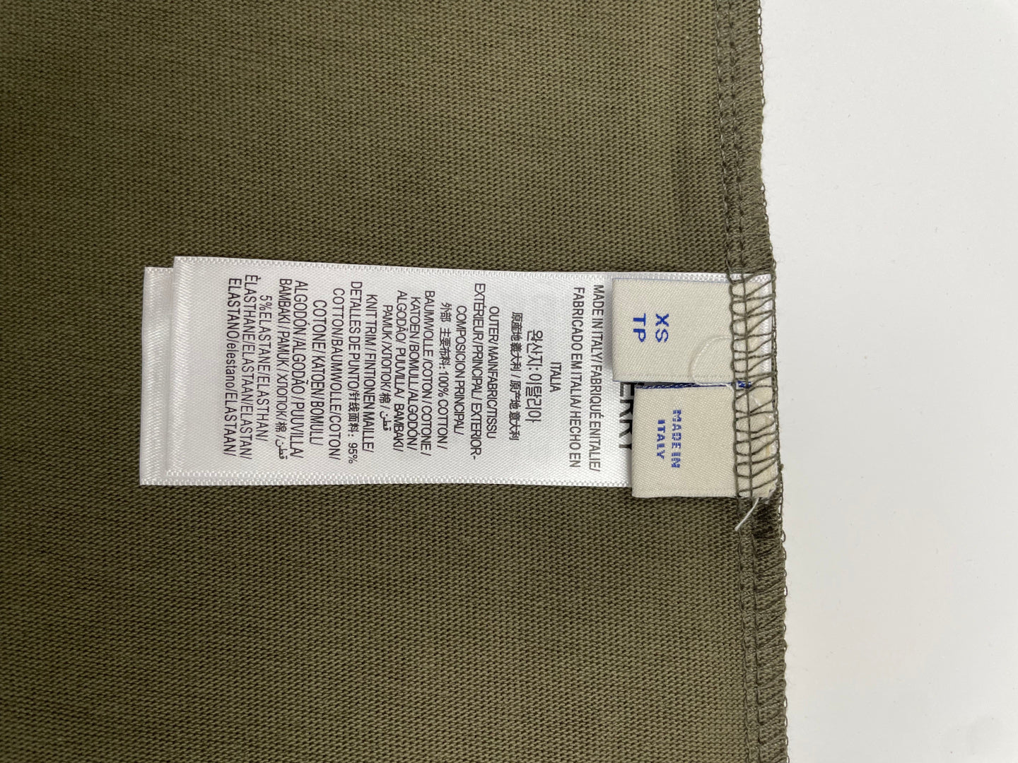 Burberry olive T-shirt hem with size and care label stitched along the inside edge