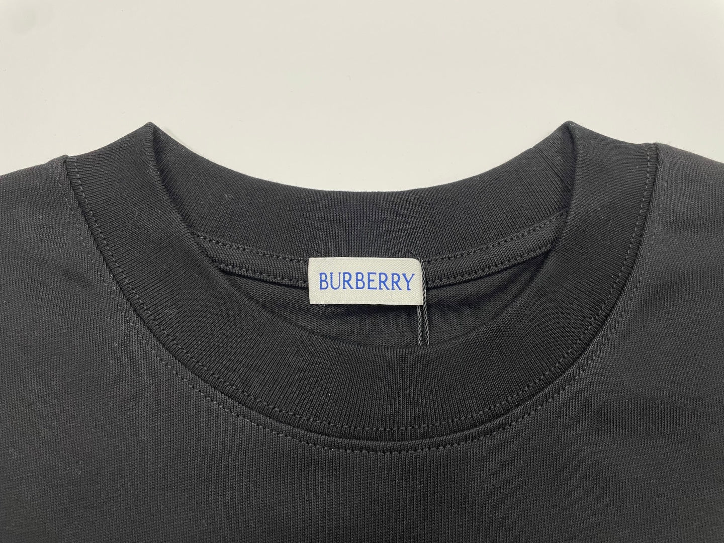 Black crew-neck Burberry T-shirt collar with brand tag at neckline