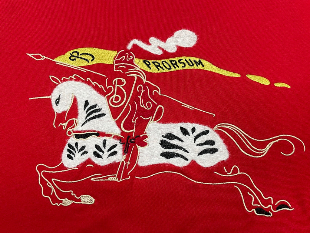 Red T-shirt fabric with white and yellow illustrated horse and pro graphic