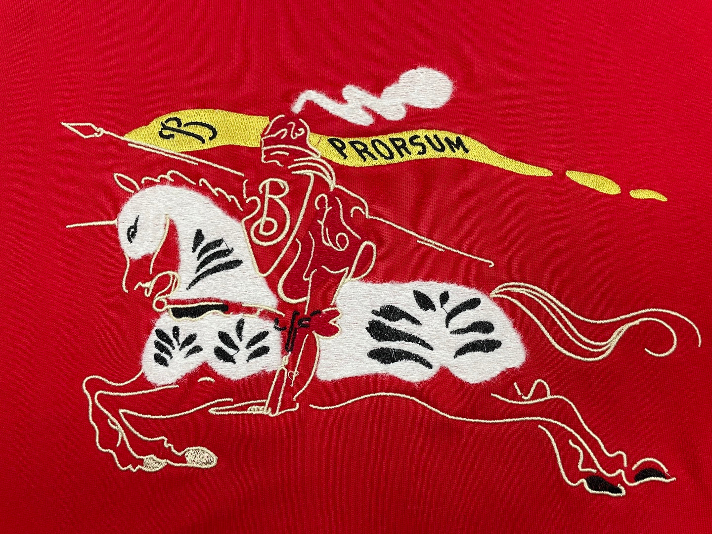 Red T-shirt fabric with white and yellow illustrated horse and pro graphic