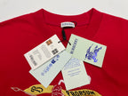 Red T-shirt with hanging price and info tags near the collar
