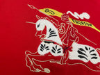 Red T-shirt fabric close-up of white and black horse illustration